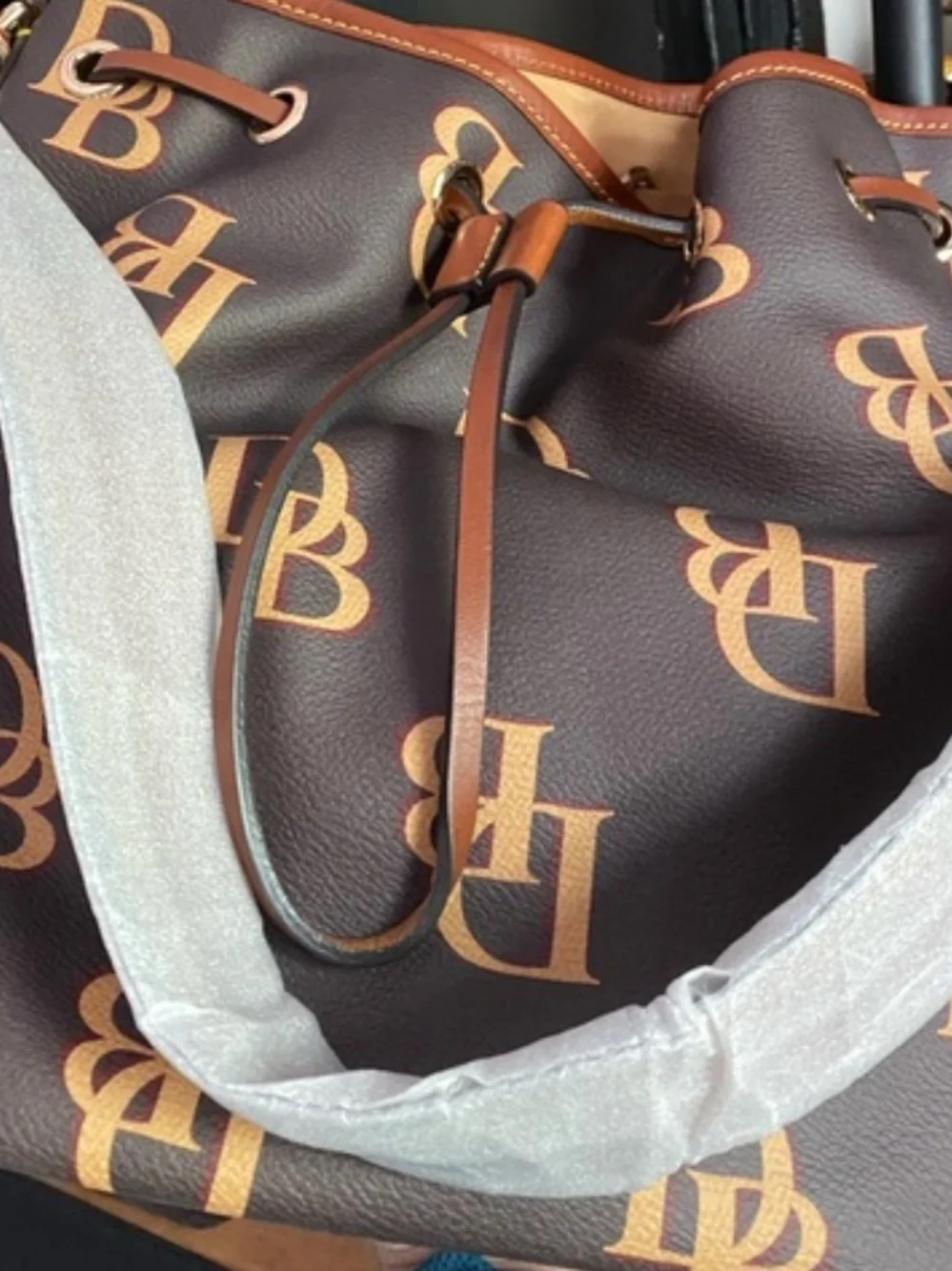 Dooney & Bourke Black and Tan Monogram Drawstring Bucket Bag
